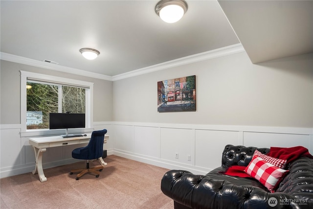 office area with ornamental molding, a wainscoted wall, visible vents, and carpet flooring