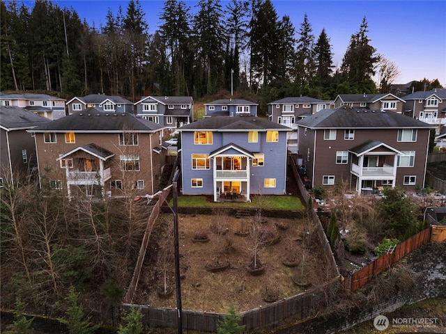 rear view of property with fence private yard and a residential view