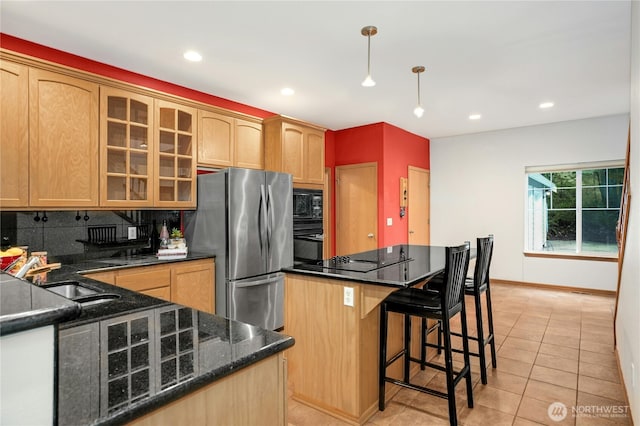 kitchen featuring decorative light fixtures, black appliances, sink, light tile patterned floors, and decorative backsplash