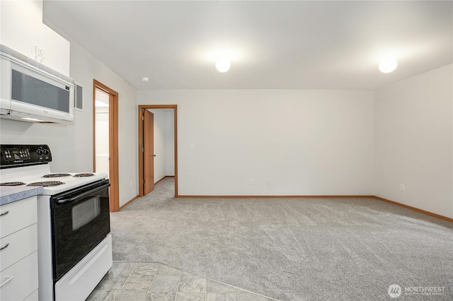 kitchen with white cabinetry, range with electric cooktop, and light colored carpet