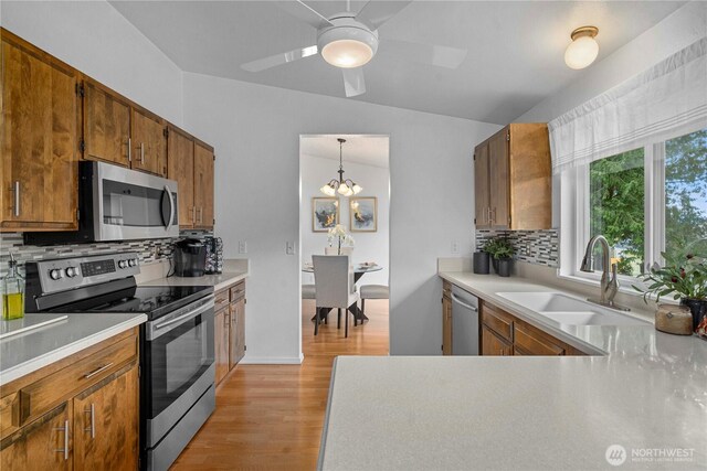 kitchen featuring appliances with stainless steel finishes, light countertops, and a sink