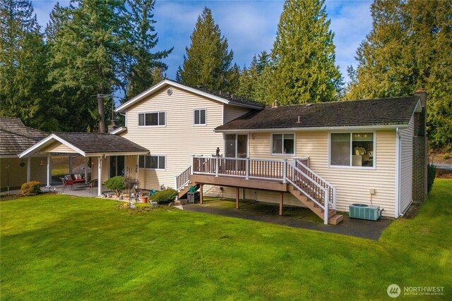 rear view of house with a deck, a yard, a patio, and stairs