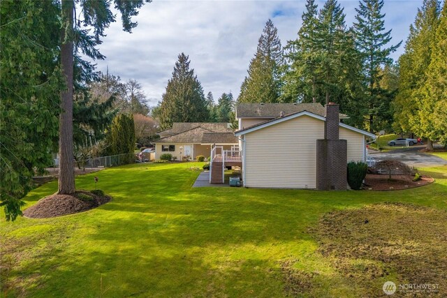 view of yard with fence and a wooden deck