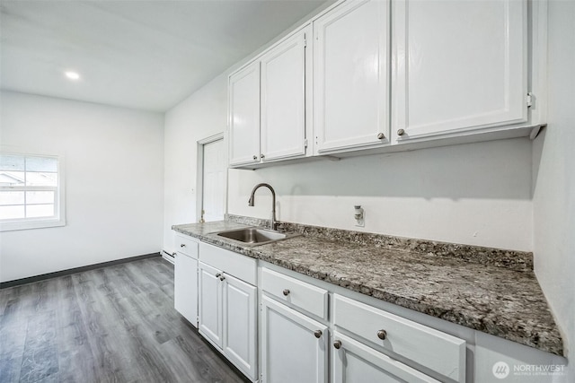 kitchen featuring white cabinetry, sink, and dark hardwood / wood-style floors