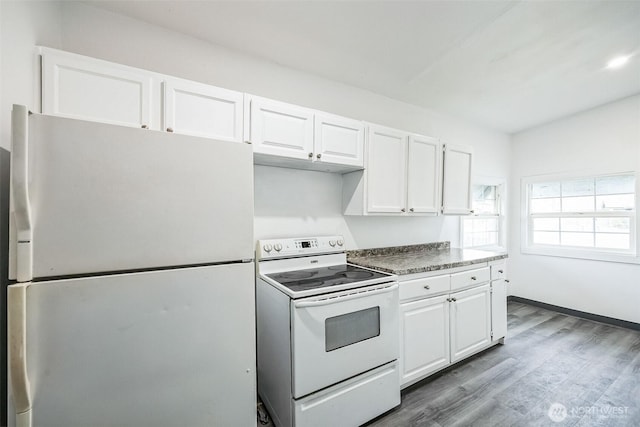 kitchen with white cabinets, white range with electric stovetop, fridge, and hardwood / wood-style floors