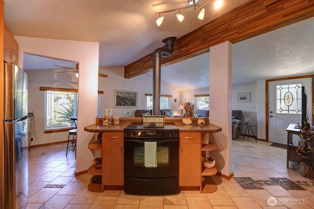 kitchen with dark countertops, lofted ceiling with beams, black range with electric stovetop, freestanding refrigerator, and a textured ceiling