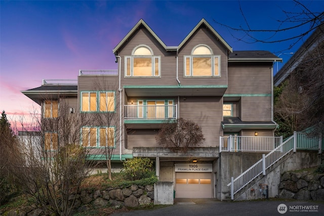 view of front of property with an attached garage and stairs