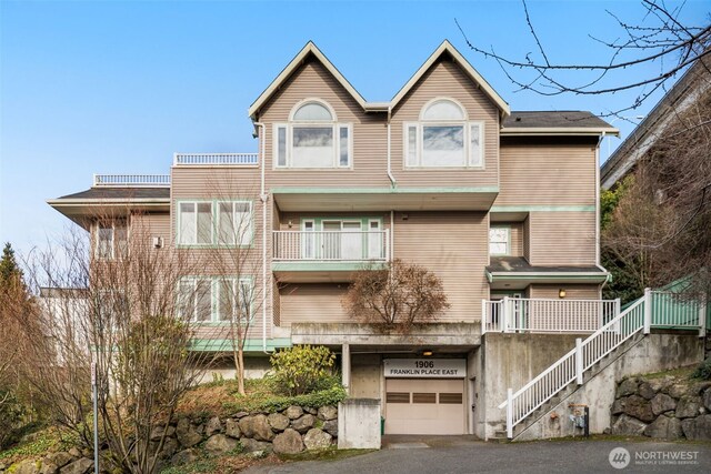 view of front of house featuring stairway and an attached garage