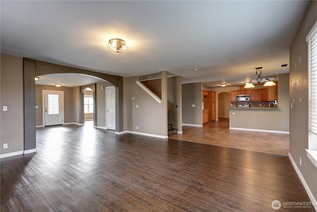 unfurnished living room featuring dark hardwood / wood-style floors