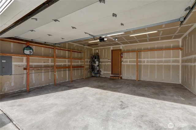 garage featuring a garage door opener, strapped water heater, and electric panel