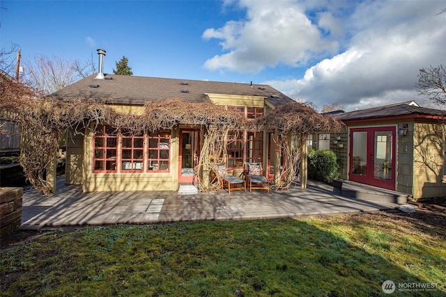 back of house with french doors, a patio area, and a lawn