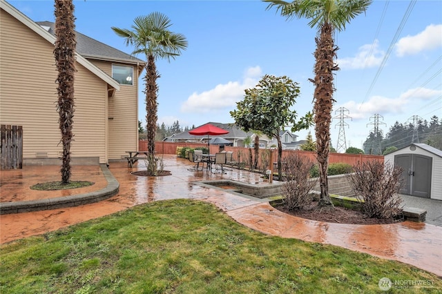 view of yard with a shed and a patio