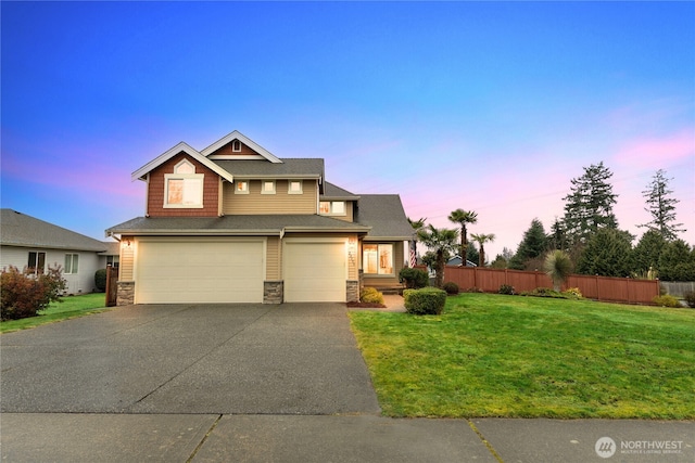 view of front of property featuring a garage and a lawn