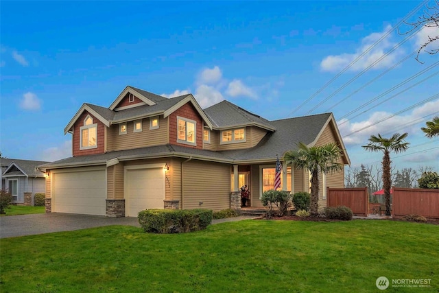 view of front of home with a garage, a front yard, fence, and aphalt driveway