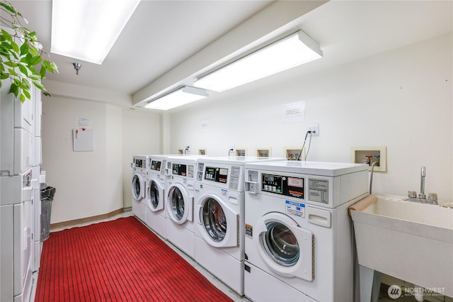 shared laundry area featuring separate washer and dryer, stacked washer / dryer, and a sink