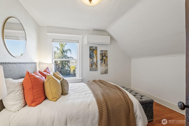 bedroom featuring lofted ceiling, a wall mounted AC, and hardwood / wood-style flooring