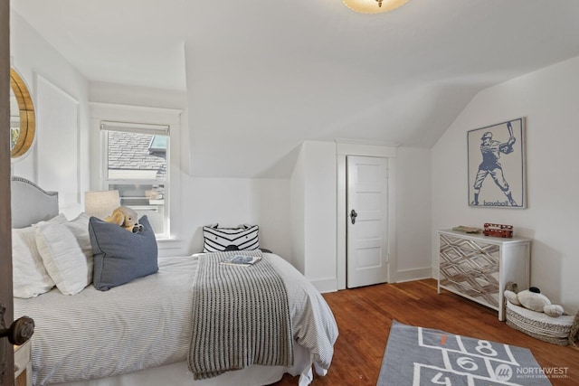 bedroom featuring dark hardwood / wood-style flooring and lofted ceiling