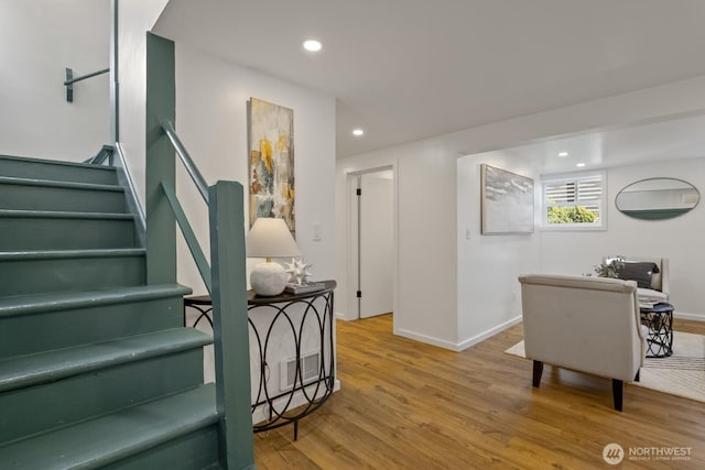 staircase with wood-type flooring