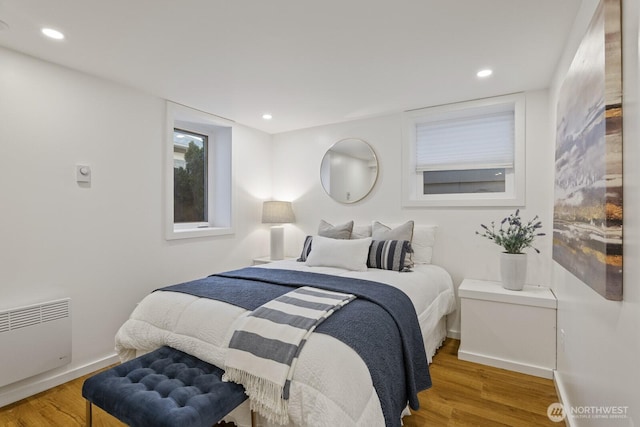 bedroom with wood-type flooring and radiator