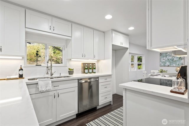 kitchen with sink, plenty of natural light, white cabinetry, dishwasher, and tasteful backsplash