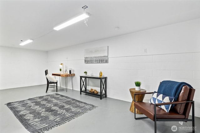 sitting room featuring concrete floors