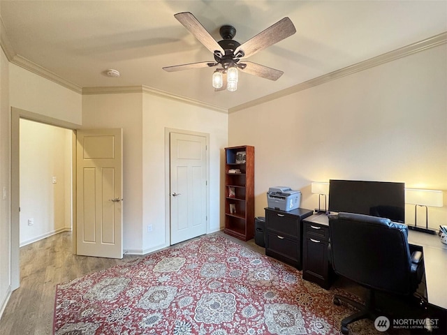 office with crown molding, baseboards, light wood finished floors, and ceiling fan