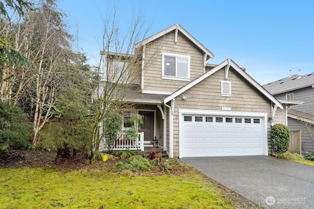 view of front of property featuring aphalt driveway, a front yard, a porch, and a garage