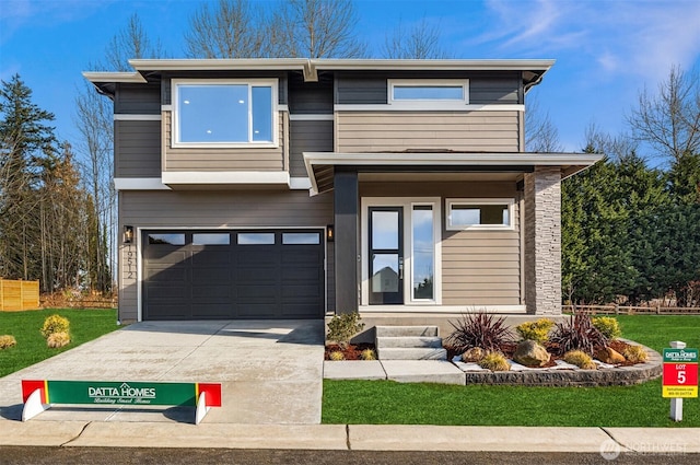 view of front of home with concrete driveway and an attached garage