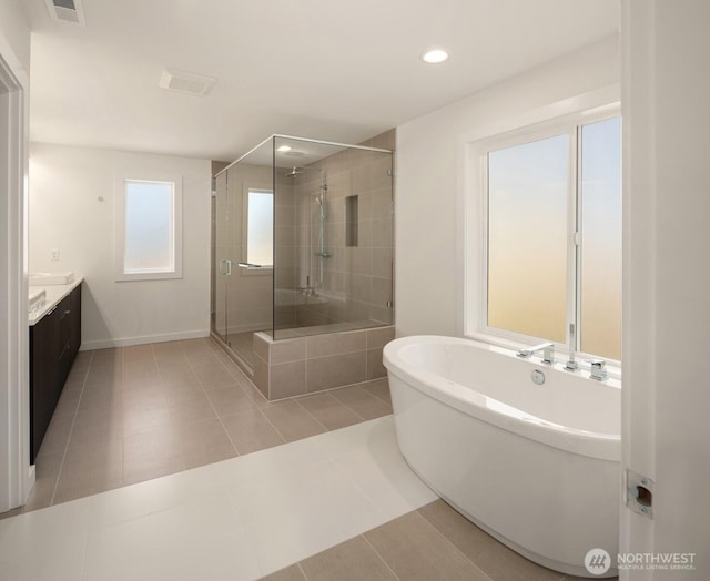 full bathroom with visible vents, tile patterned floors, a freestanding bath, vanity, and a shower stall