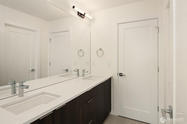 bathroom featuring double vanity, a sink, and tile patterned floors