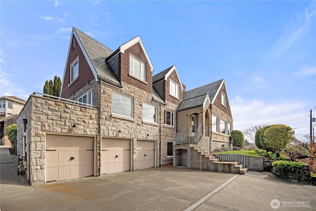 4801 Hyada Blvd NE, Tacoma, WA 98422 - view of home's exterior with an attached garage, driveway, and stone siding