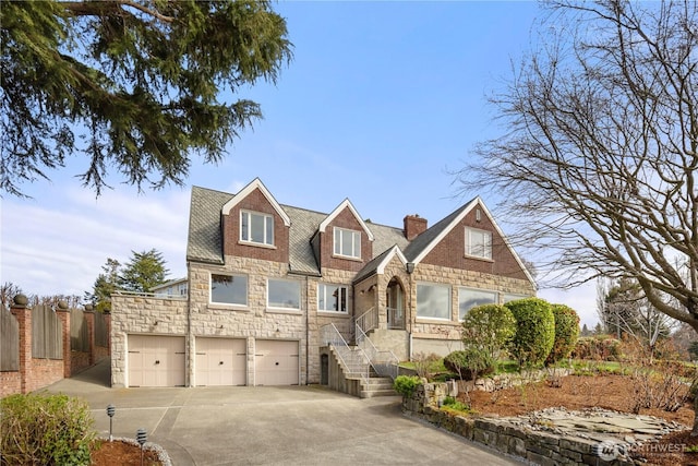 4801 Hyada Blvd NE, Tacoma, WA 98422 - view of front of property with fence, an attached garage, stone siding, a chimney, and concrete driveway