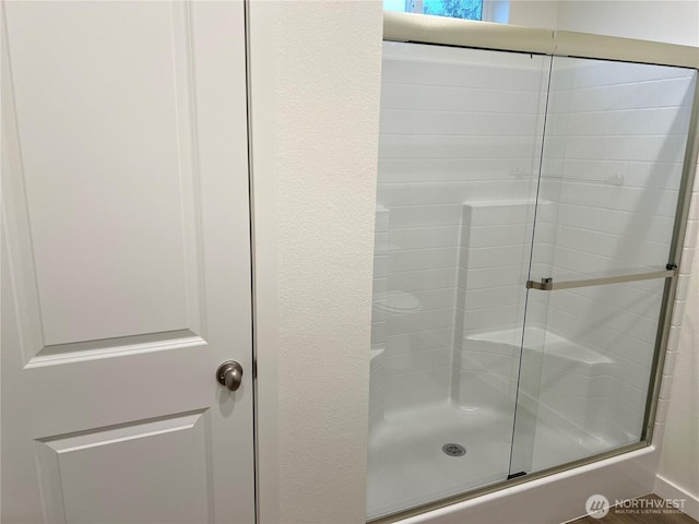 bathroom with a shower with shower door