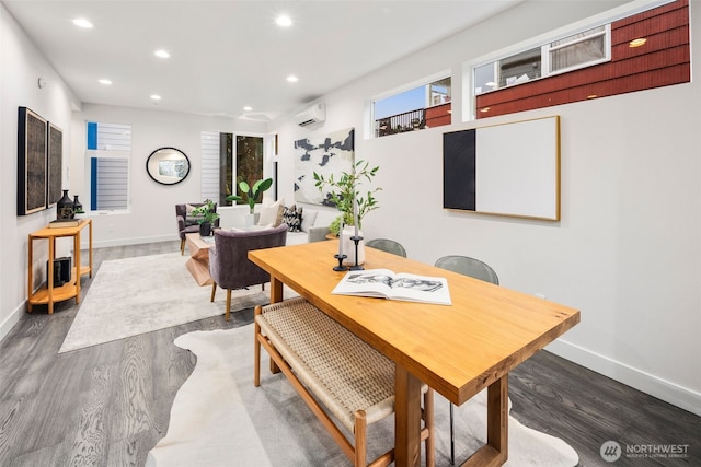 dining space featuring a wall unit AC and dark wood-type flooring