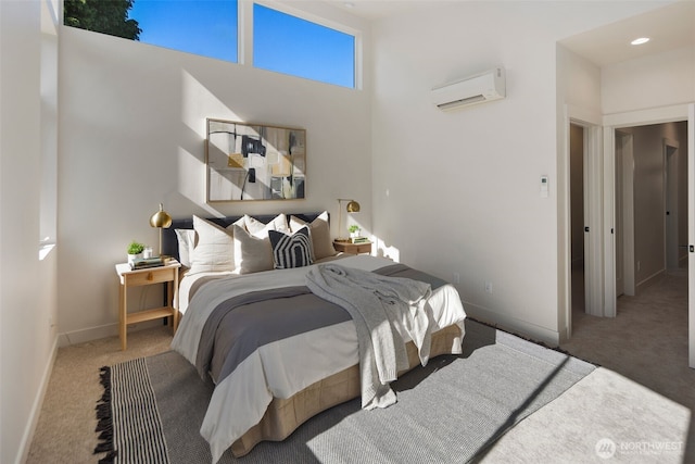 bedroom featuring an AC wall unit and carpet