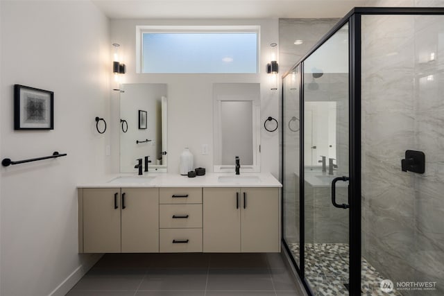 bathroom featuring tile patterned flooring, an enclosed shower, and vanity