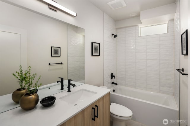 full bathroom with vanity, toilet, and tiled shower / bath