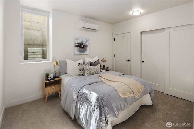 bedroom with carpet floors and an AC wall unit