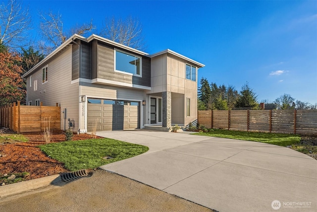 view of front facade with a garage, fence, and driveway