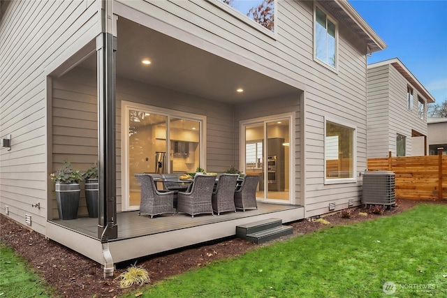 rear view of property with a yard, a deck, central AC, and fence