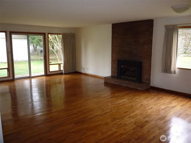 unfurnished living room featuring a fireplace and hardwood / wood-style flooring