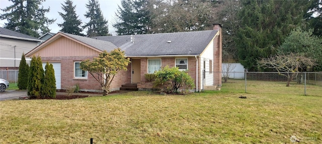 view of front of house with a garage and a front lawn