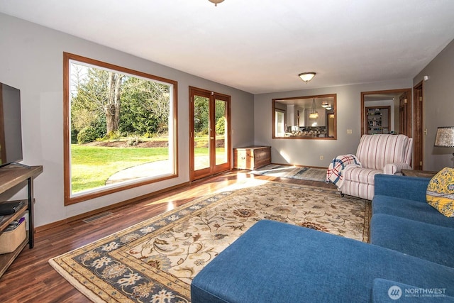 living area with dark wood-type flooring and visible vents