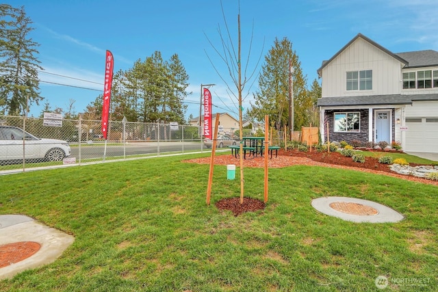 view of playground with a yard and fence