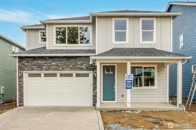 view of front of house featuring a garage, a shingled roof, stone siding, concrete driveway, and board and batten siding