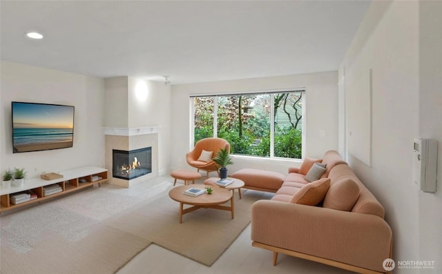 living room featuring a glass covered fireplace and recessed lighting