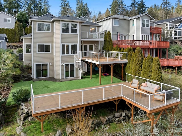 back of house with a residential view, an outdoor living space, a lawn, and a wooden deck