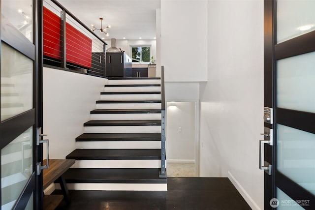 stairway with an inviting chandelier