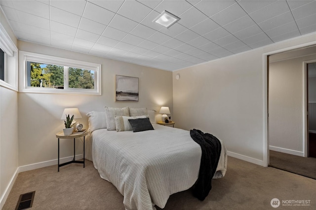 bedroom with light colored carpet, visible vents, and baseboards