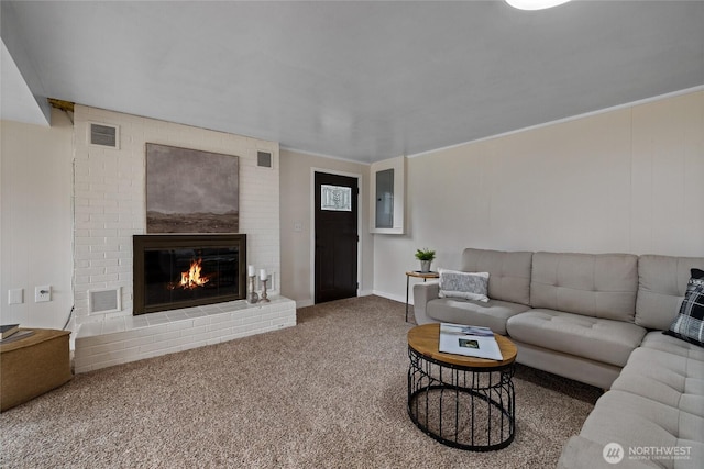 carpeted living area with a fireplace and visible vents